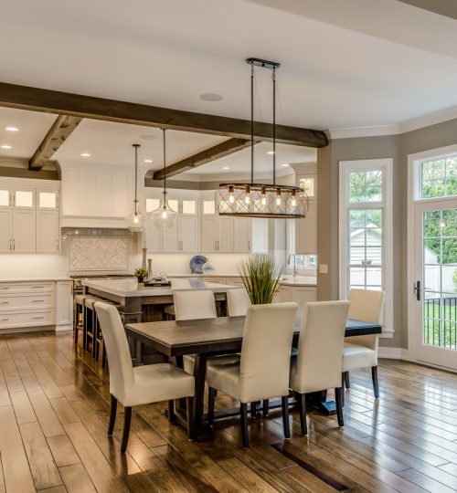 Wood beams on ceiling with two pendant lights hang over island