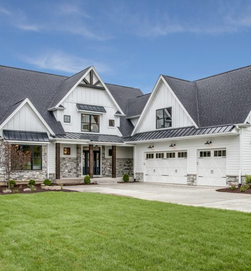 Large house with steep roof and side entry three car garage